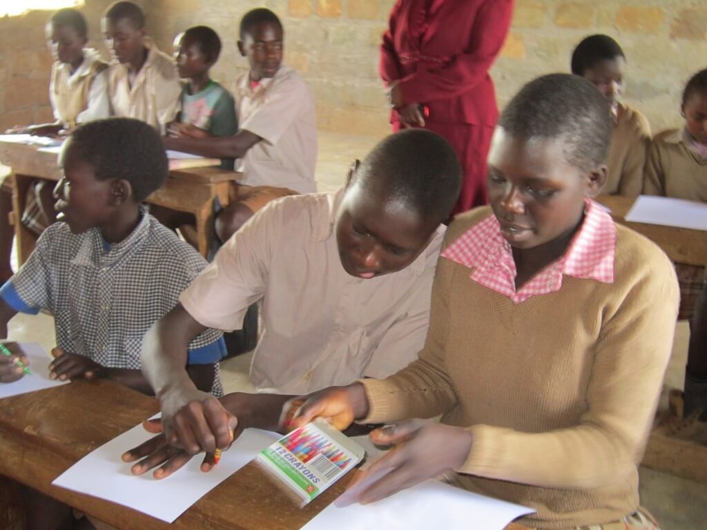 students tracing handprints in Kenya