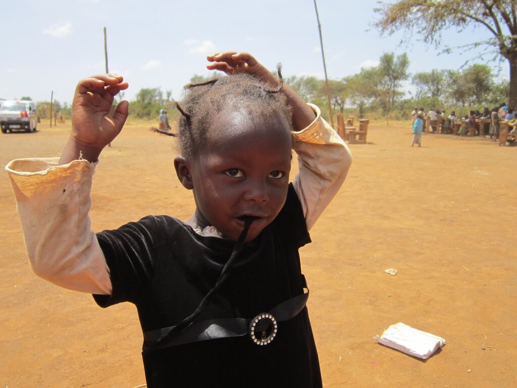a dusty schoolyard shows in this child's hair in Kampi Ya Moto