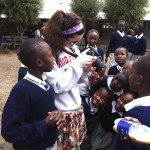 an American student showing her camera to Kenyan students