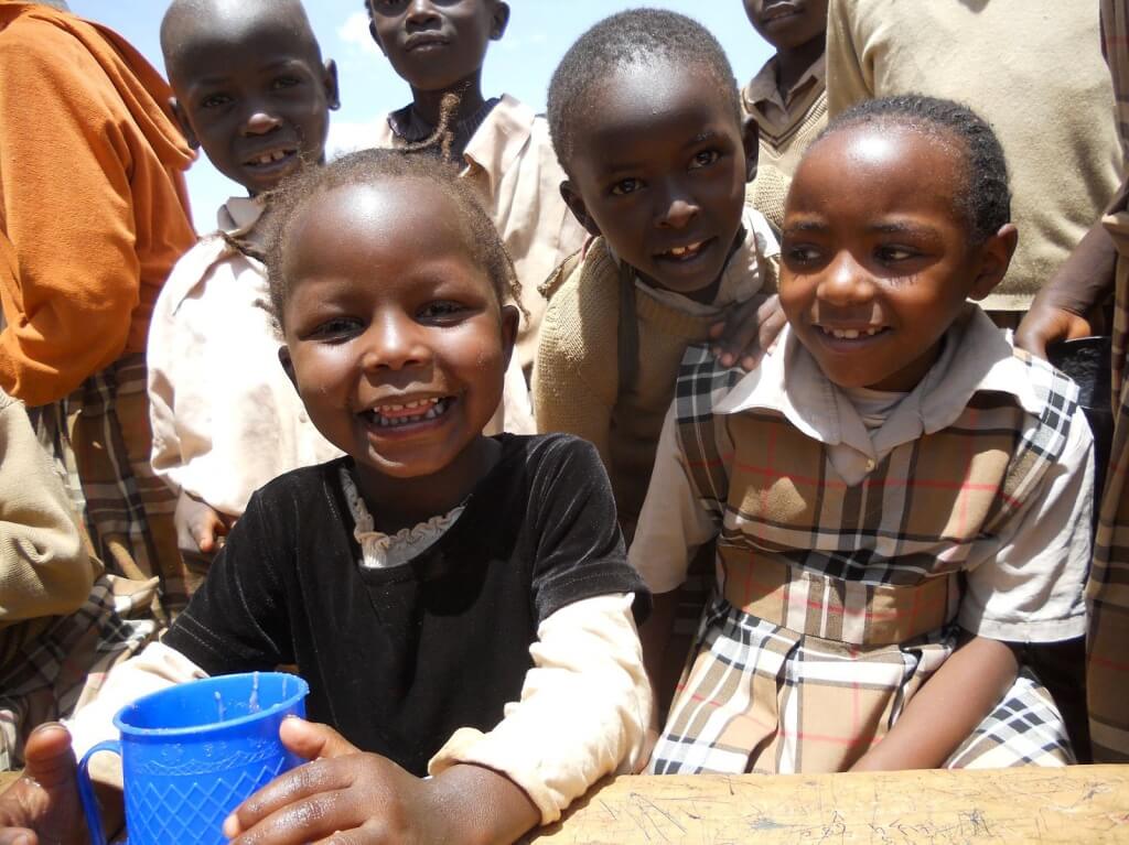 Children receiving their lunch in Kampi Ya Moto, Kenya