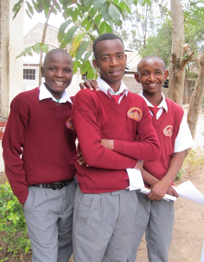 3 young adult boys from Bishop Donovan Secondary School in red sweaters 