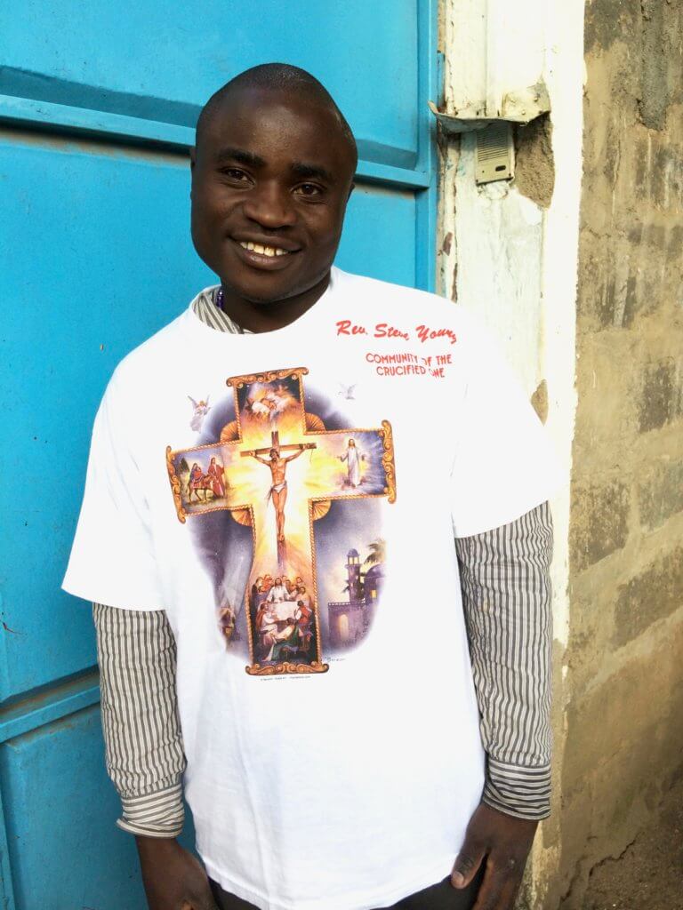 young Kenyan man with a new t-shirt bearing the cross