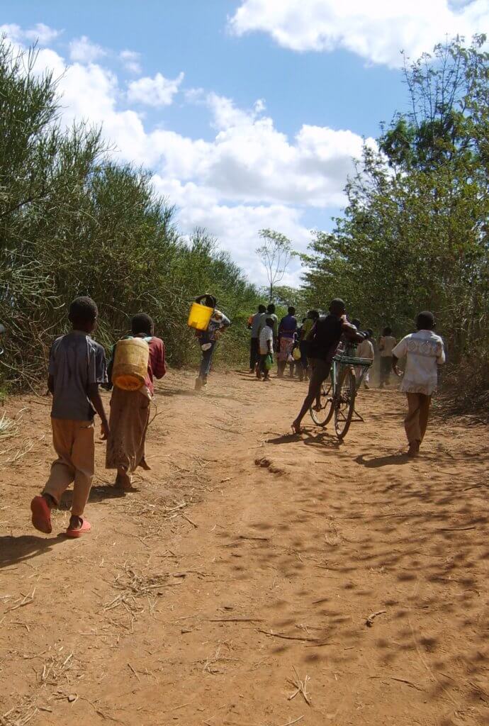 Carrying maji or water from the river in Kampi Ya Moto< Kenya