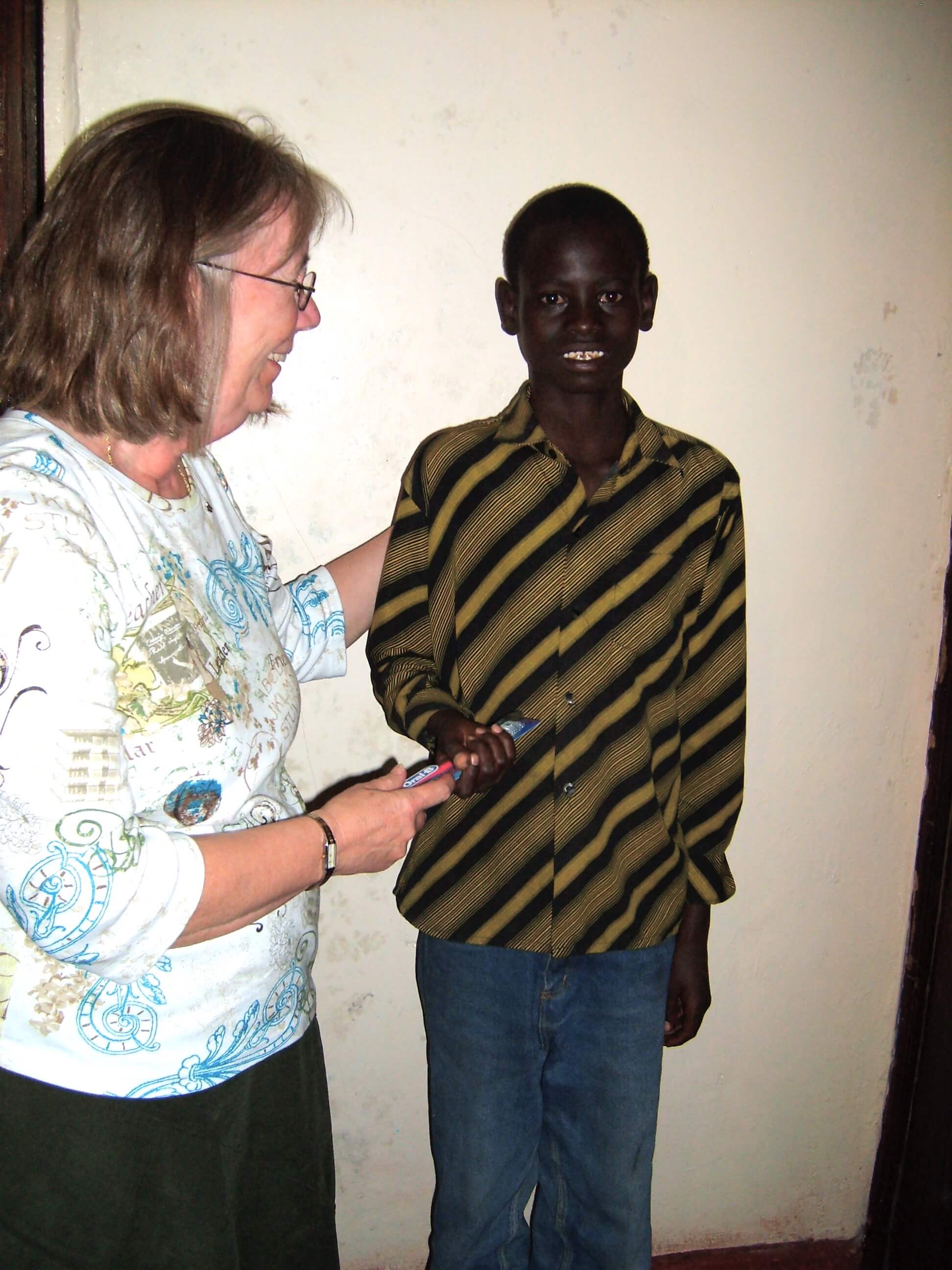 providing scholarships: Tracy Braun from EC helping a student in Kenya