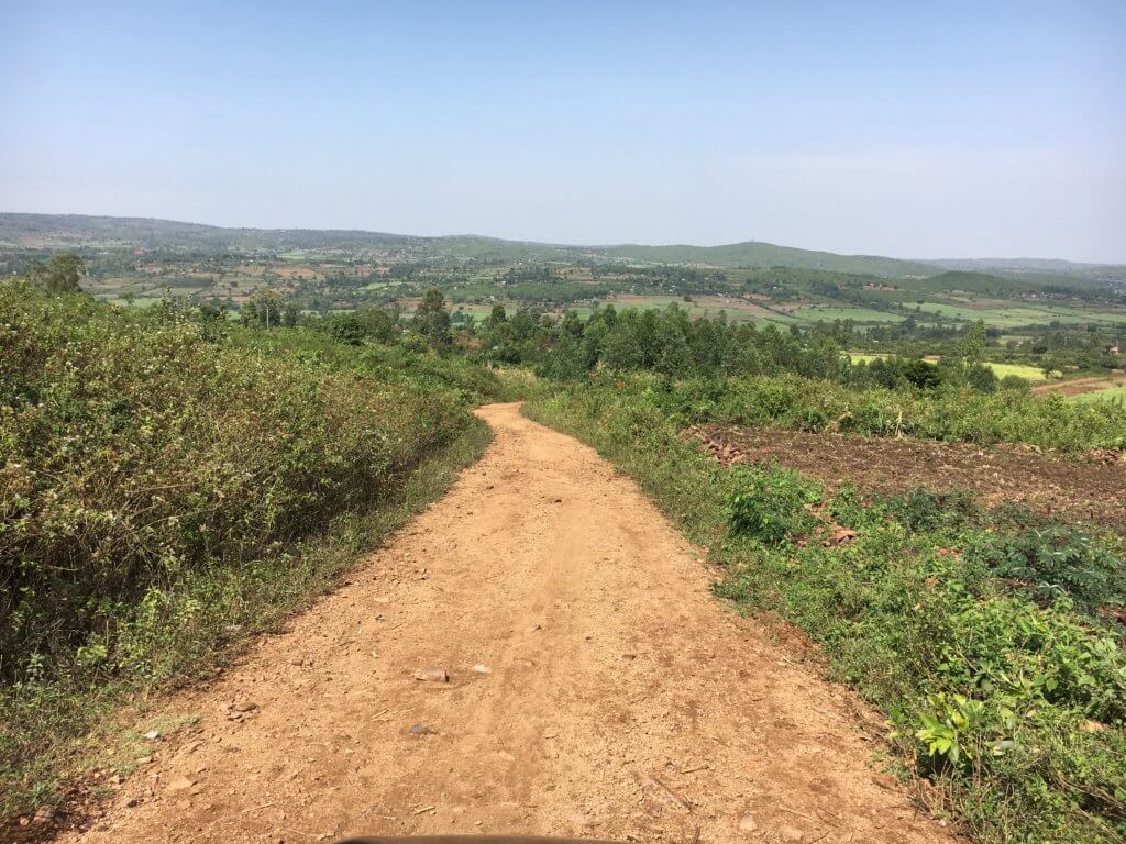 Beautiful fields and rocky dirt road leading to Miruya Primary School