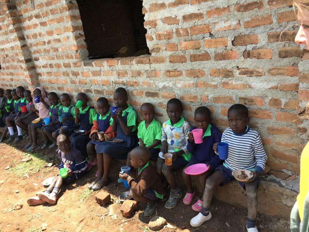 feeding children: children eating lunch at Miruya Primary School