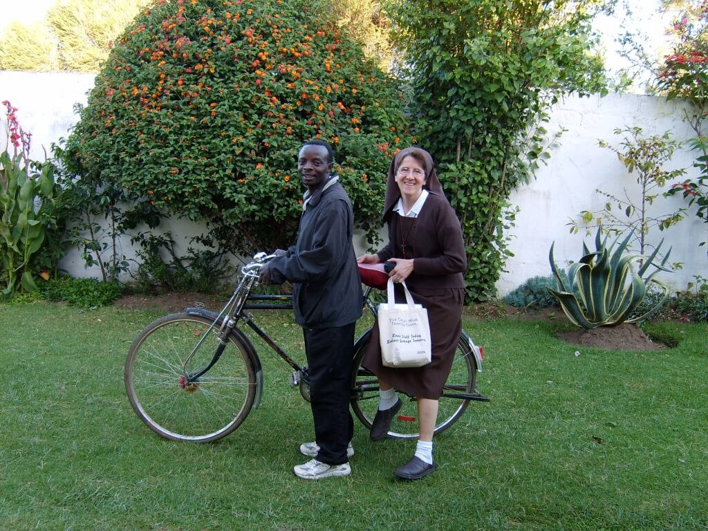 Ruth on the back of a bicycle in Kenya