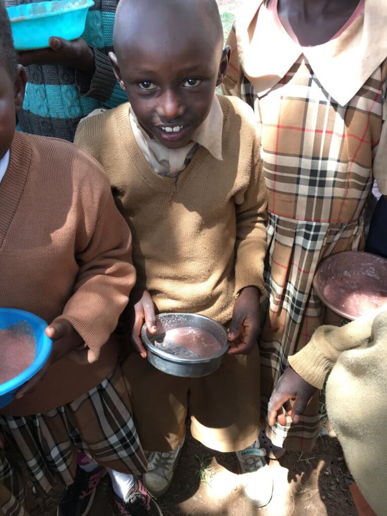 Really good news for this young Kenyan boy holding a bowl of steaming porridge